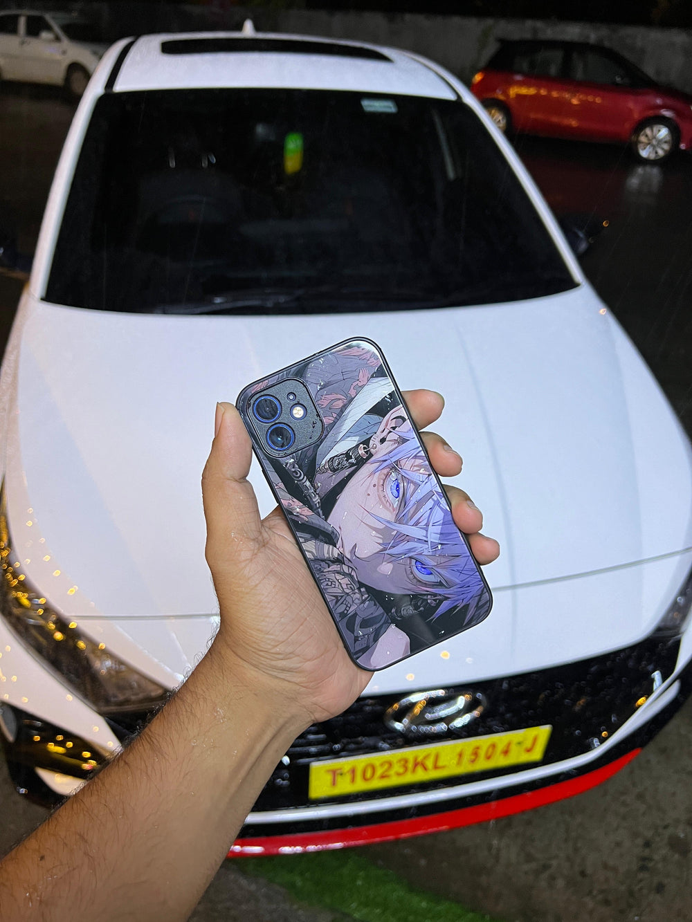 Anime printed phone case held in hand, showing its reflective finish